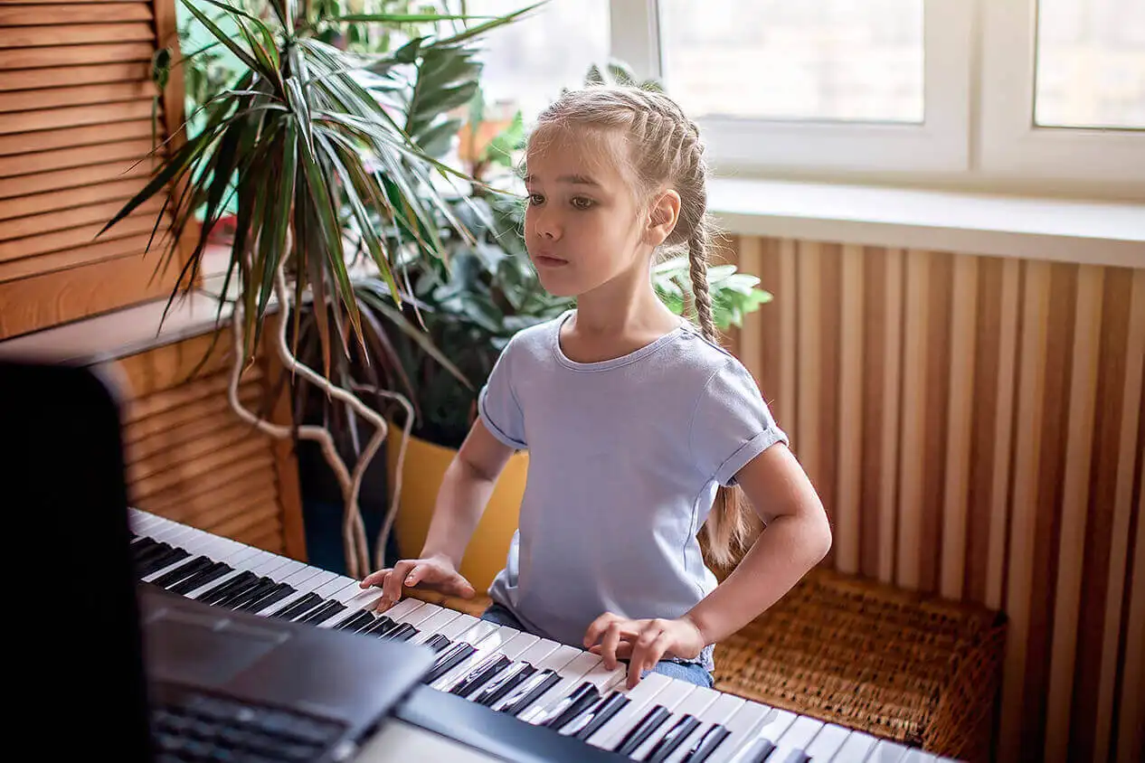 A kid playing Casio Kids Keyboard SA76